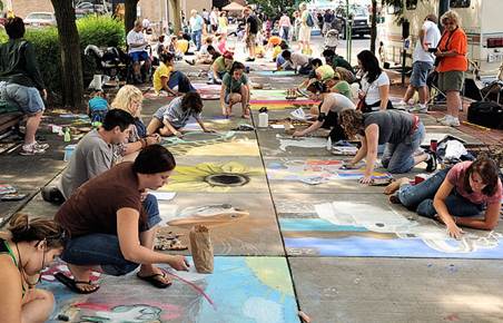 People create sidewalk chalk art.
