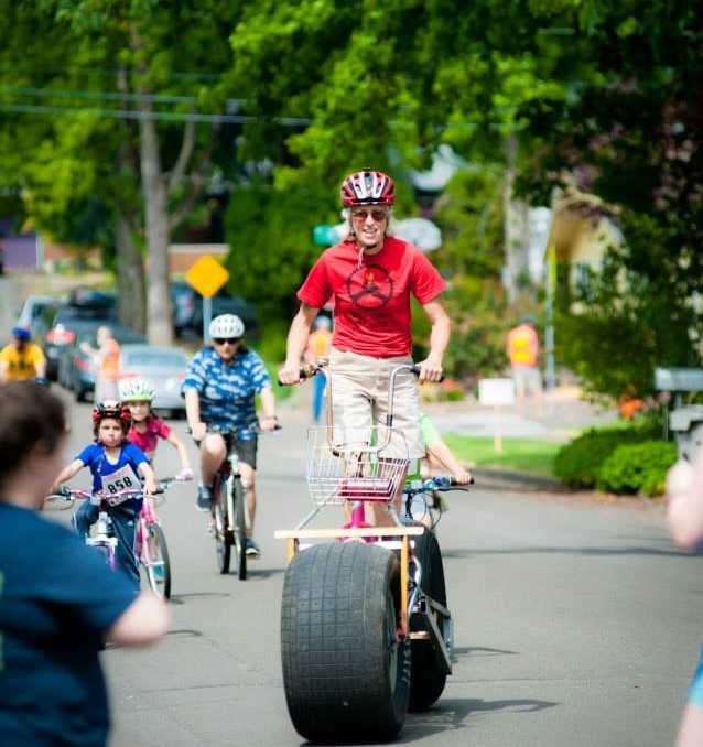 A person riding a bike with very large tires.