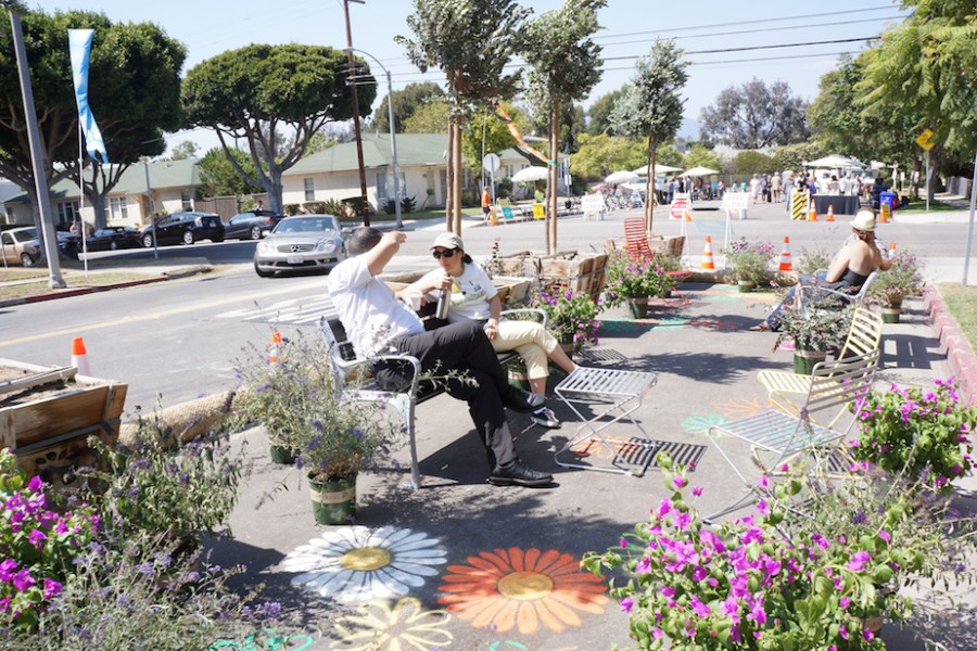 Pop up garden with bench seating on a street.