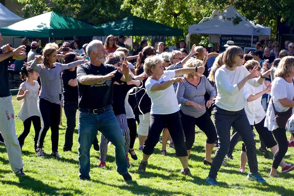 People dance in a park.