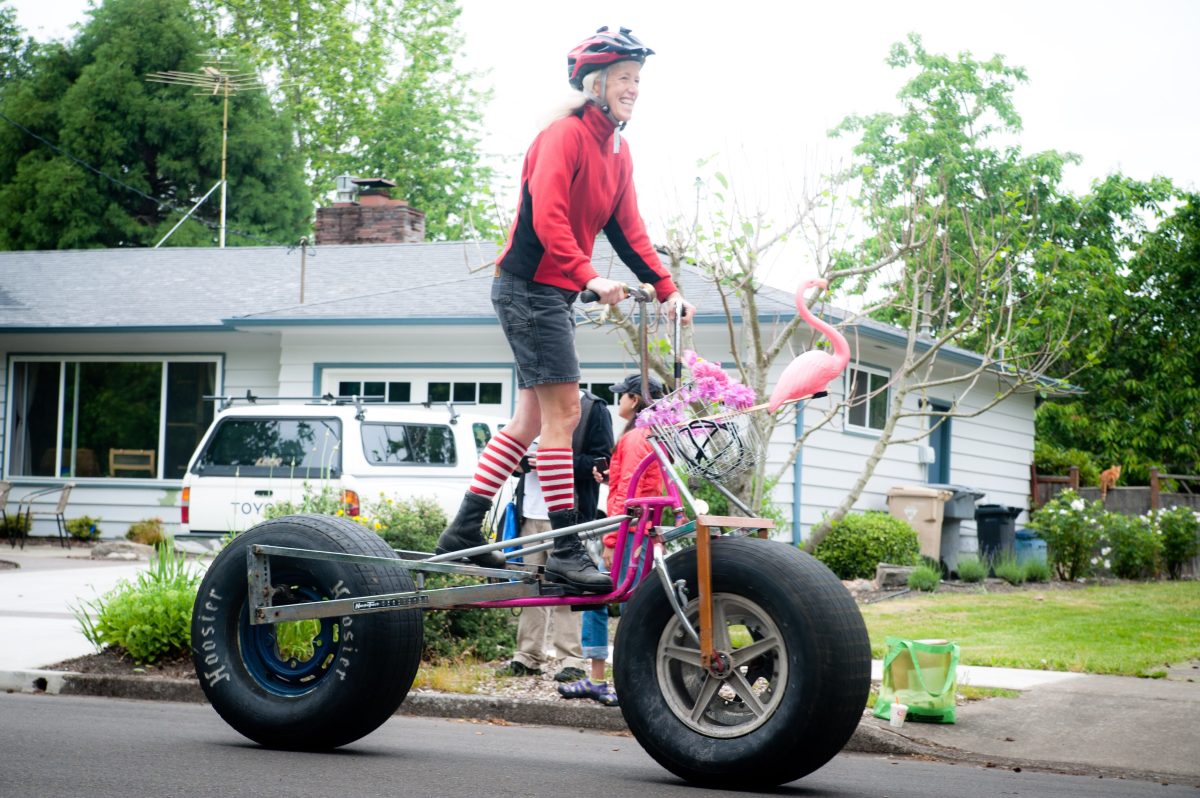 A person rides a bike with oversized wheels.