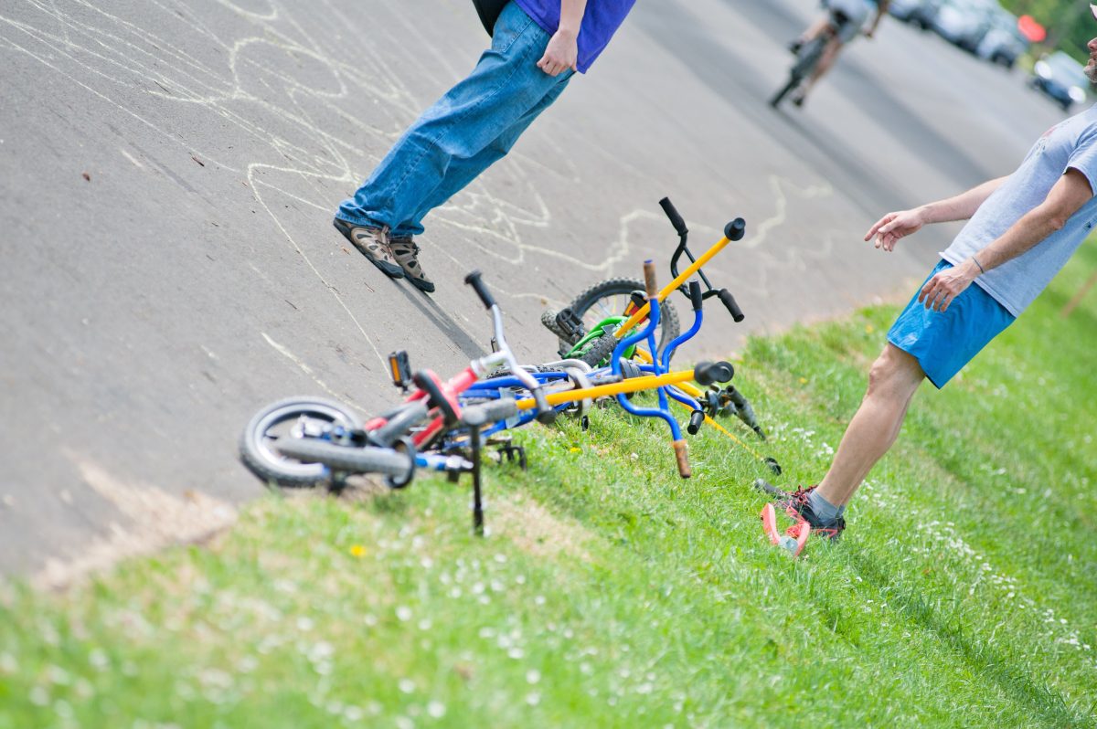 Kids' bike parked along the edge of the grass.
