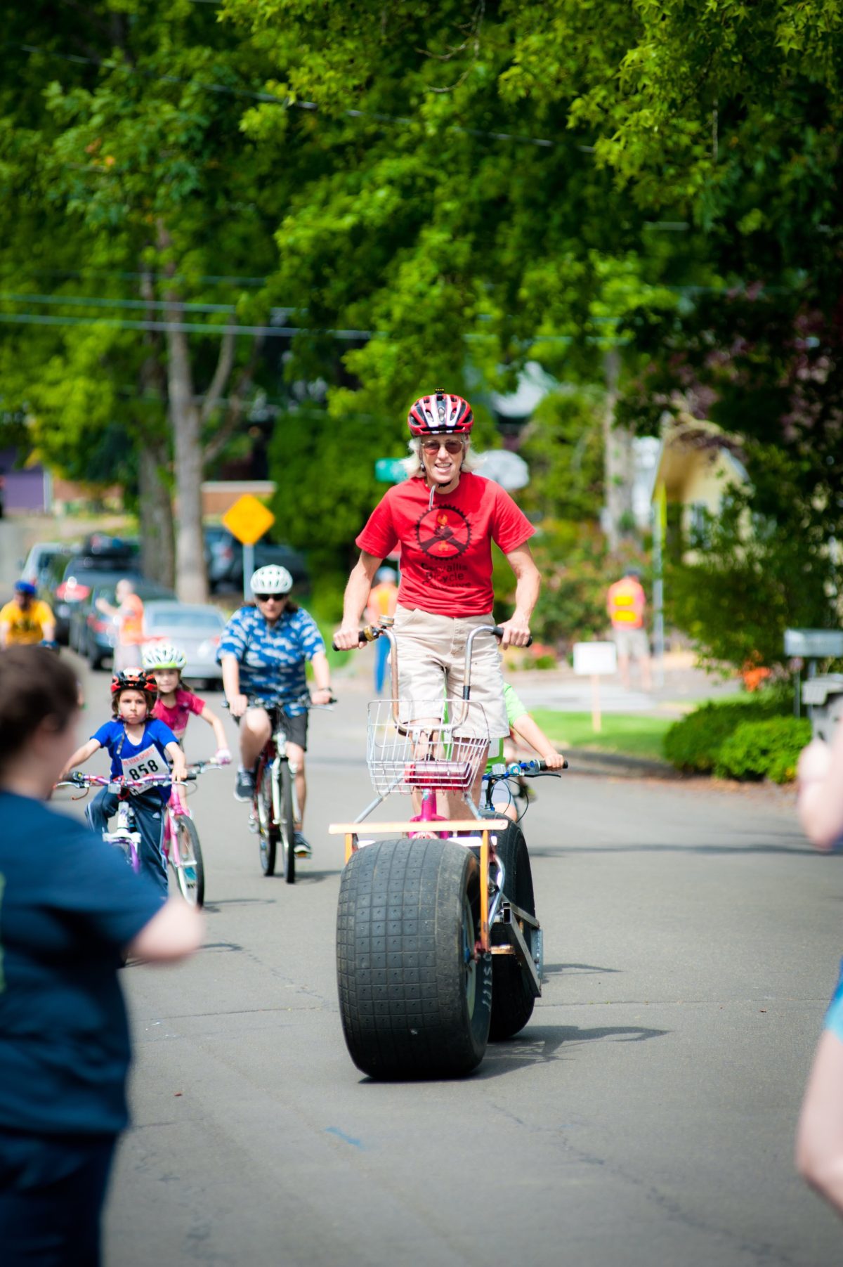 A person rides a bike with very large tires.