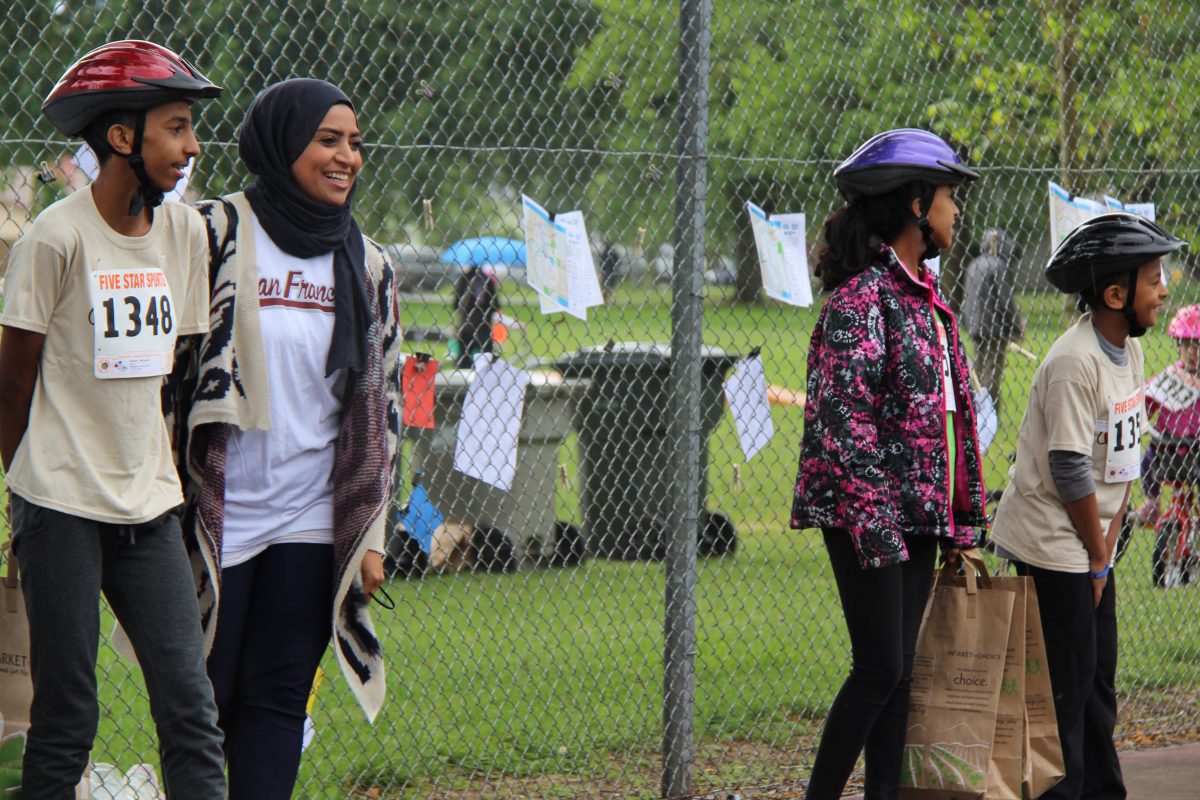 People in bicycle helmets looking at something.