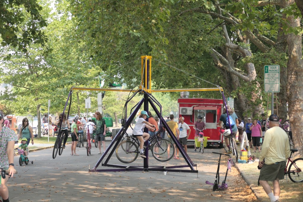 People ride a bicycle carnival ride.
