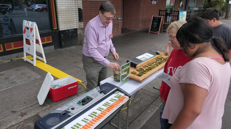 People look at the pickle piano