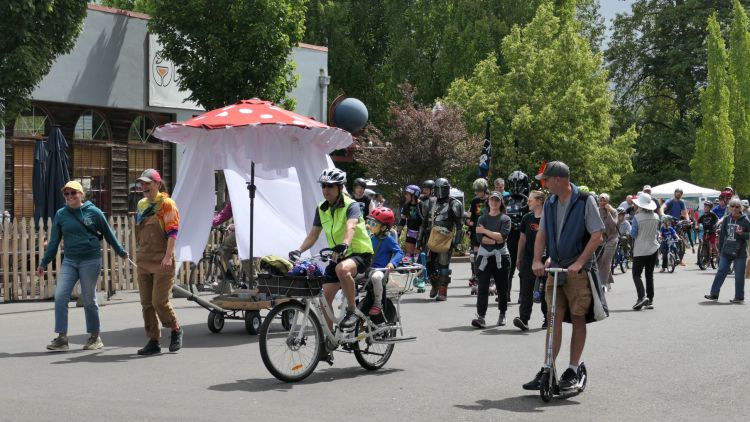 People walk, ride, and scoot in the parade