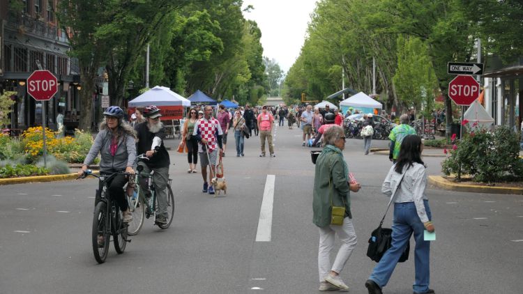 People walk and bike down 2nd Street