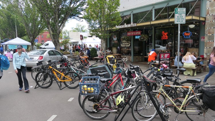 Bikes fill the racks in front of American Dream Pizza